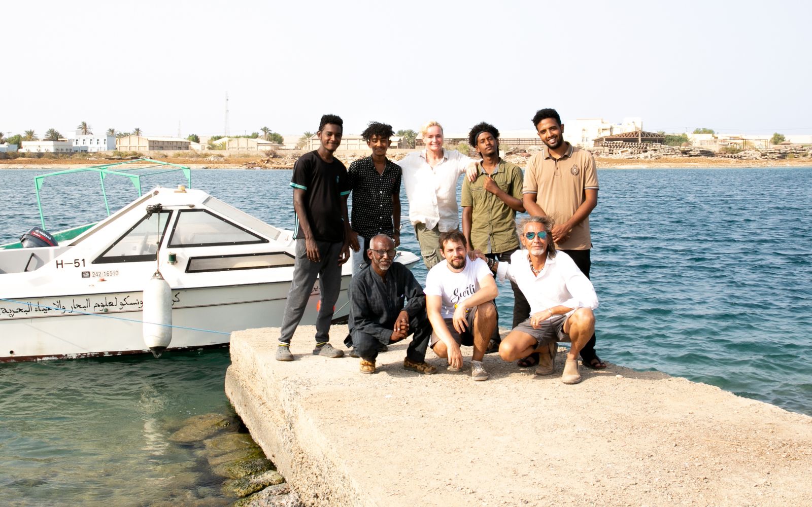 Operation Red Sea team and local collaborators near Red Sea University boat