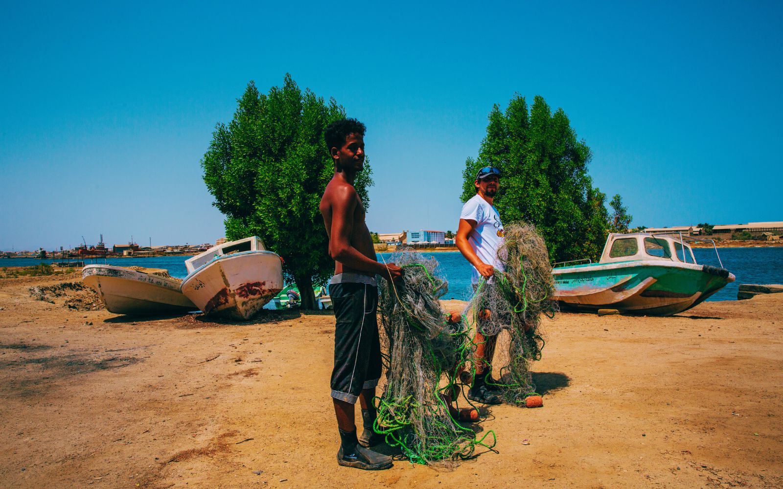 Volunteers handling removed fishing nets and coastal waste